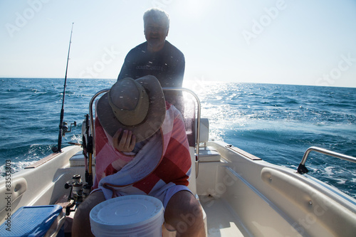 Italy, Puglia, TA, Ginosa, Marina di Ginosa, Men fishing on boat in Italy