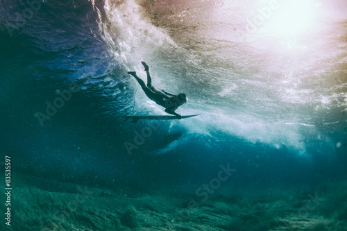 Female surfer duck diving under a wave in Pacific Ocean, Hawaii, America, USA #83535597