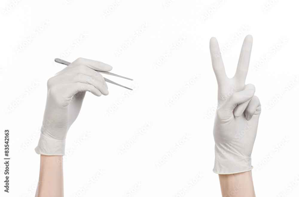 Fototapeta premium doctor's hand in a white glove holding tweezers isolated studio