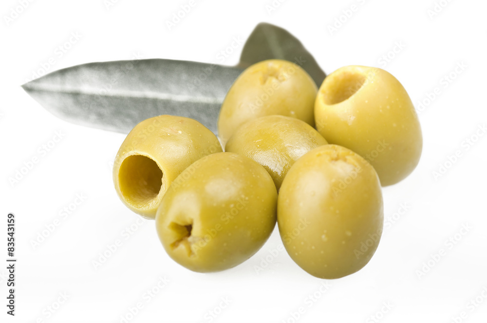 Pitted green olives close up on the white Pitted green olives close up on the white