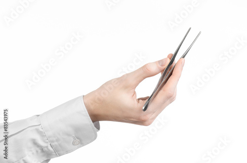 a doctor s hand holding tweezers isolated on white background