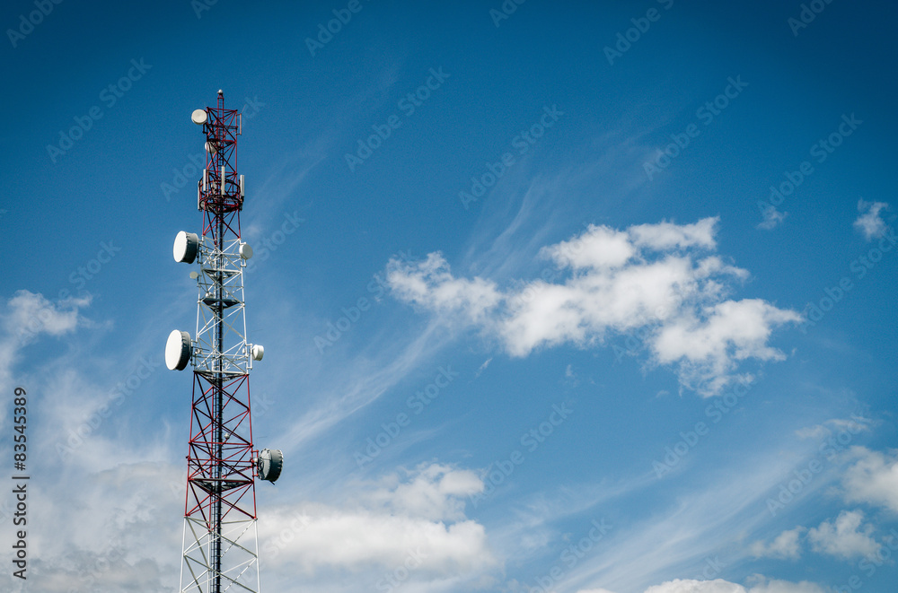 Aerial mast with many dishes and antennas with sky and clouds Aerial mast with many dishes and antennas with sky and clouds