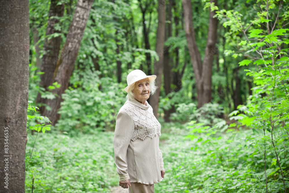 Portrait of a lovely old woman smiling outdoors Portrait of a lovely old woman smiling outdoors