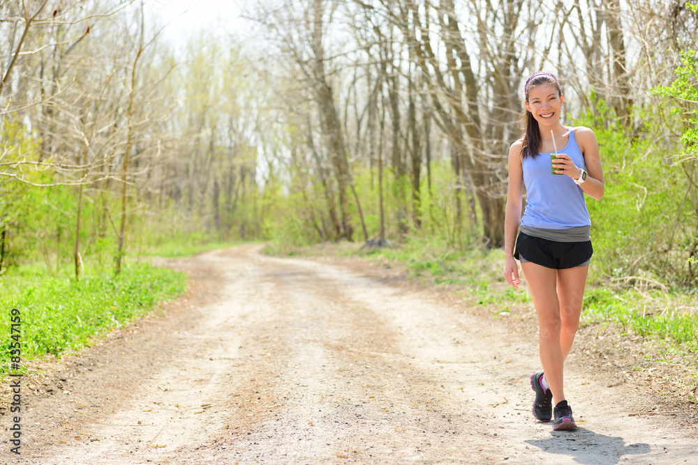 Woman runner drinking green smoothie Woman runner drinking green smoothie
