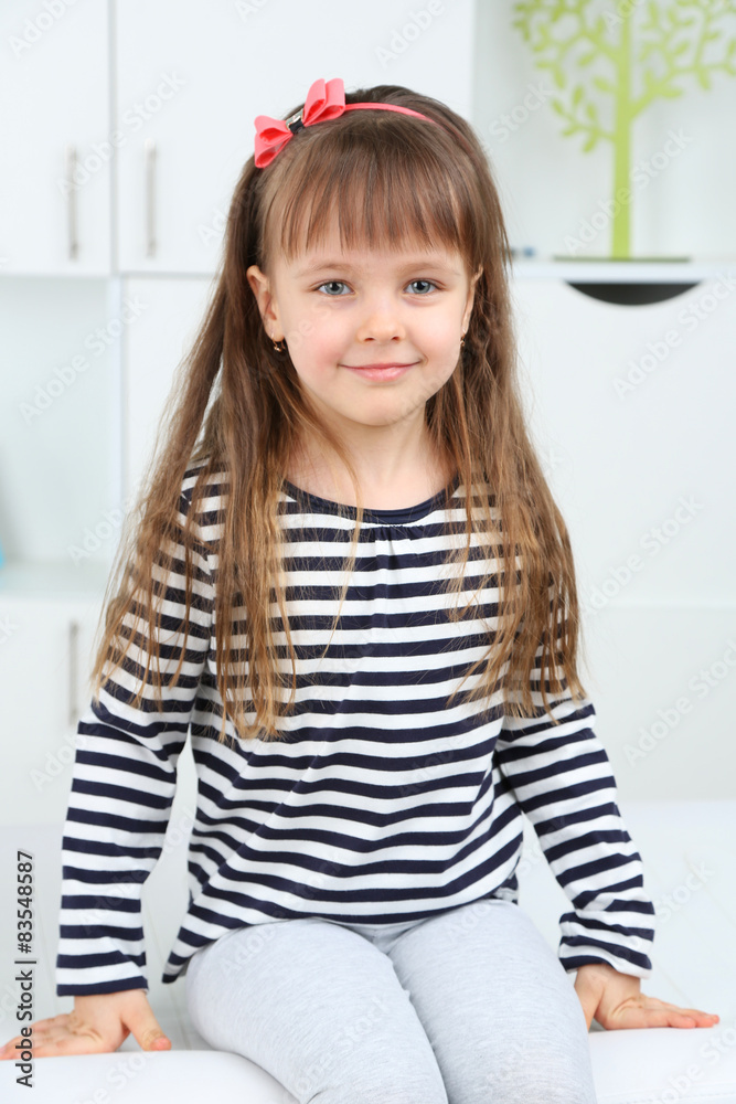 Portrait of cute little girl on home interior background Portrait of cute little girl on home interior background