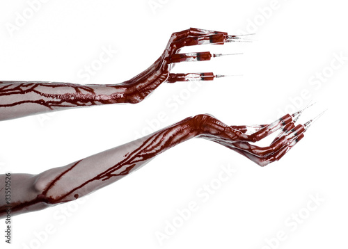 Bloody hand with syringe on the fingers, toes syringes in studio