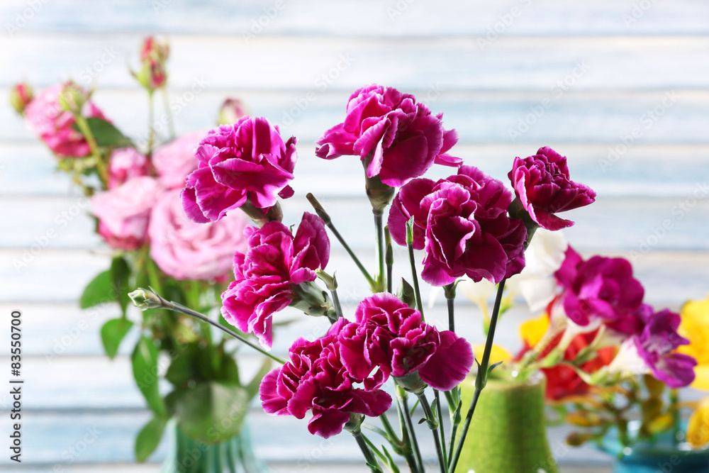 Different beautiful flowers in vases close up