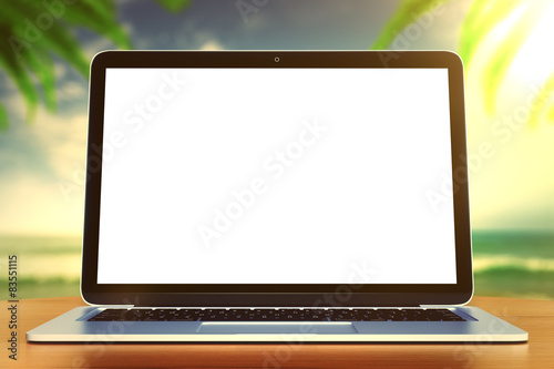 laptop on a wooden table on the beach  mock up