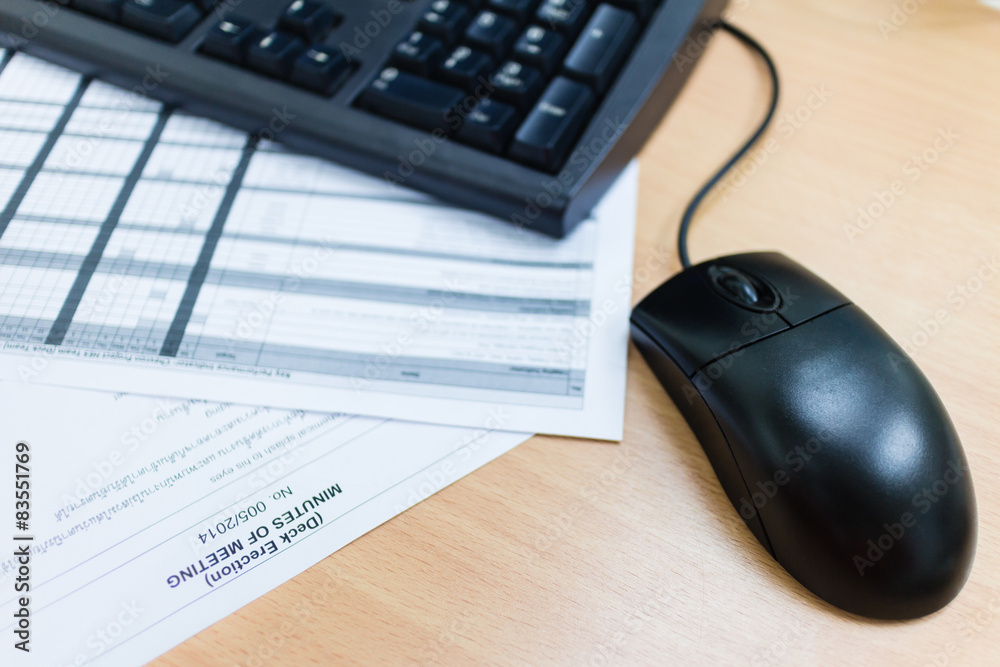 computer mouse on desk and sheet