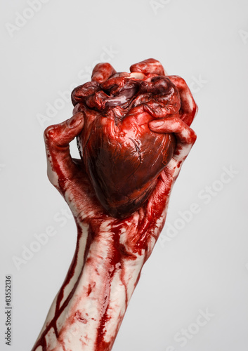 terrible bloody hand hold torn bleeding human heart isolated