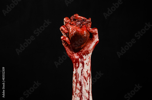 terrible bloody hand hold torn bleeding human heart isolated