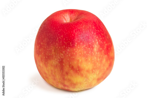 Close-up of a whole red apple with a shadow, isolated on white