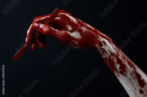 Bloody hand with a scalpel, a nail zombie, demon, maniac