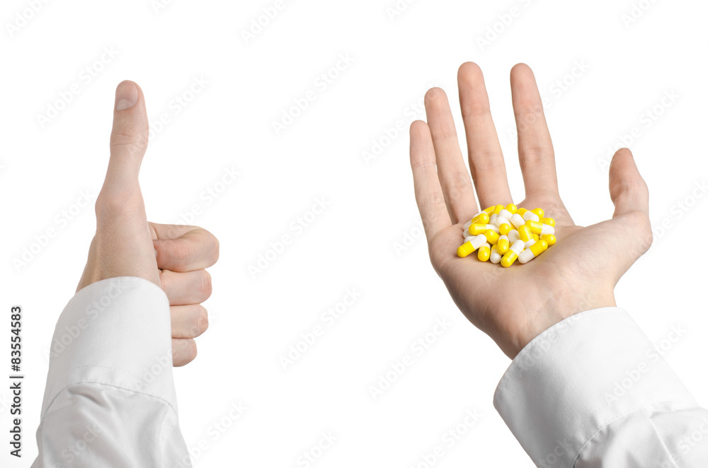 Obraz premium doctor's hand holding a yellow capsule for health isolated 