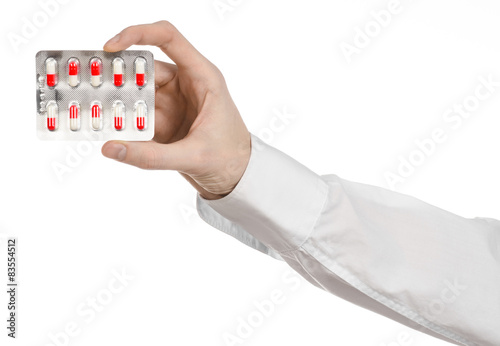 doctor's hand holding a red capsule for health isolated