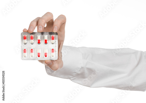 doctor's hand holding a red capsule for health isolated