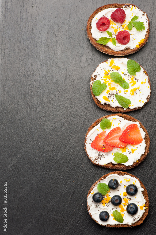 Bruschetta with goat cheese and fresh berries. top view