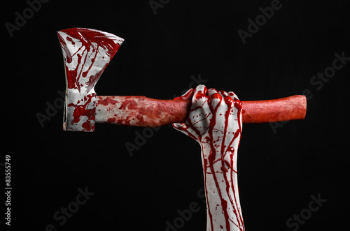 bloody hand holding a bloody butcher's ax isolated in studio © Parad St