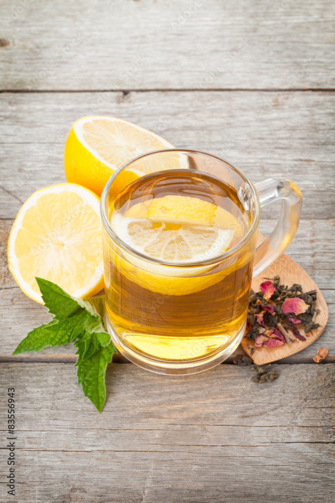 Green tea with lemon and mint on wooden table Green tea with lemon and mint on wooden table