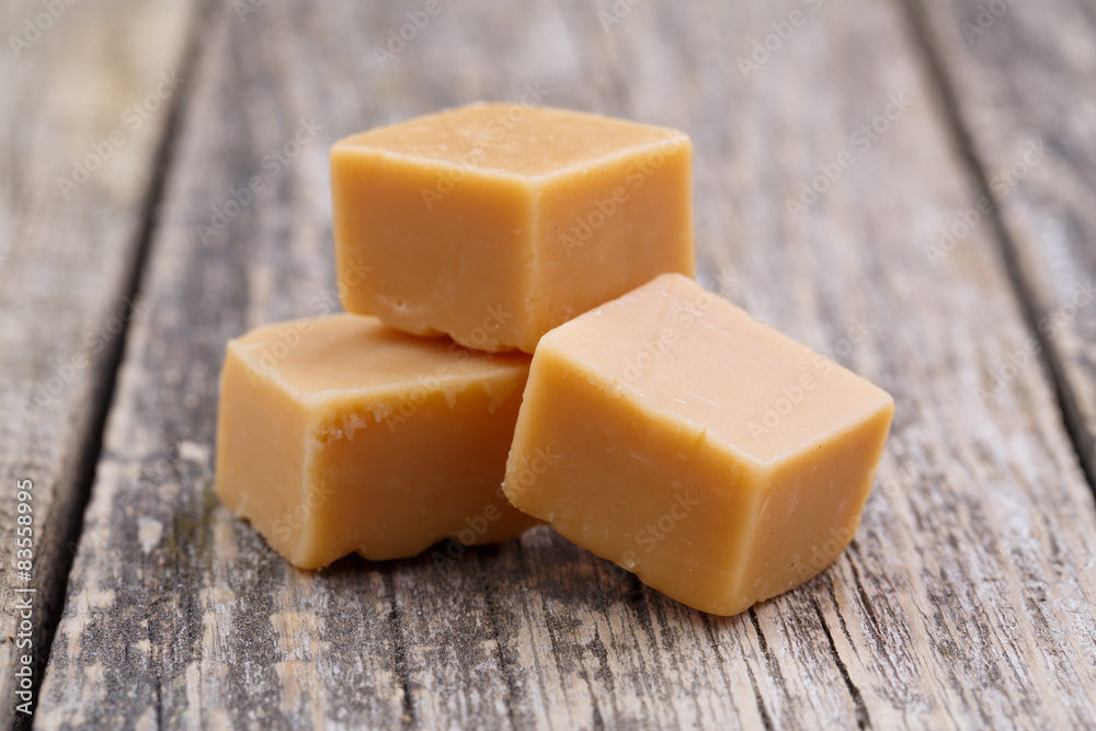 Tasty toffees on wooden background. Tasty toffees on wooden background.