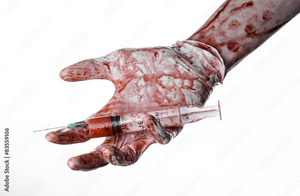 Obraz premium bloody hands of the doctor holding a bloody syringe