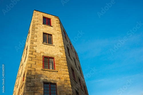 Fototapeta Naklejka Na Ścianę i Meble -  Oddly Shaped Building Against Blue Sky
