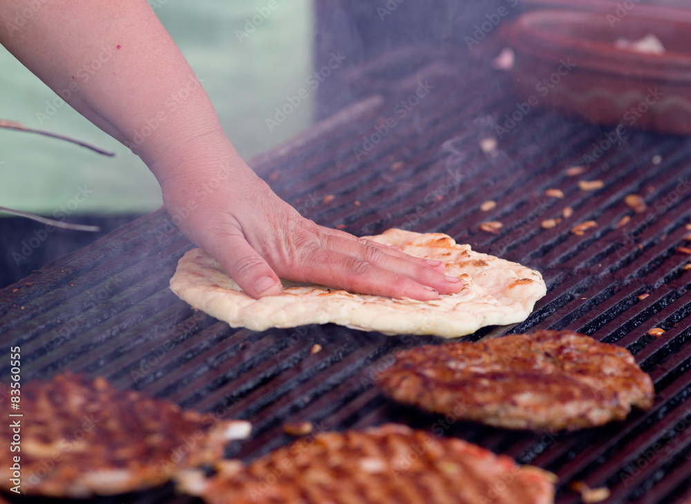 Burgers and flat bread on barbecue