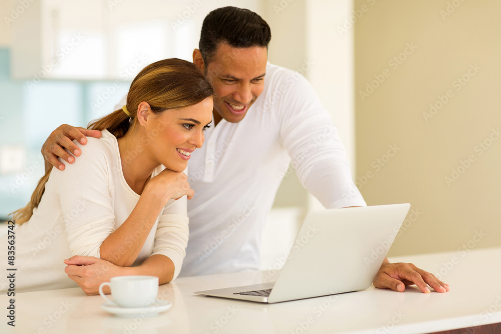 couple using laptop while having coffee couple using laptop while having coffee