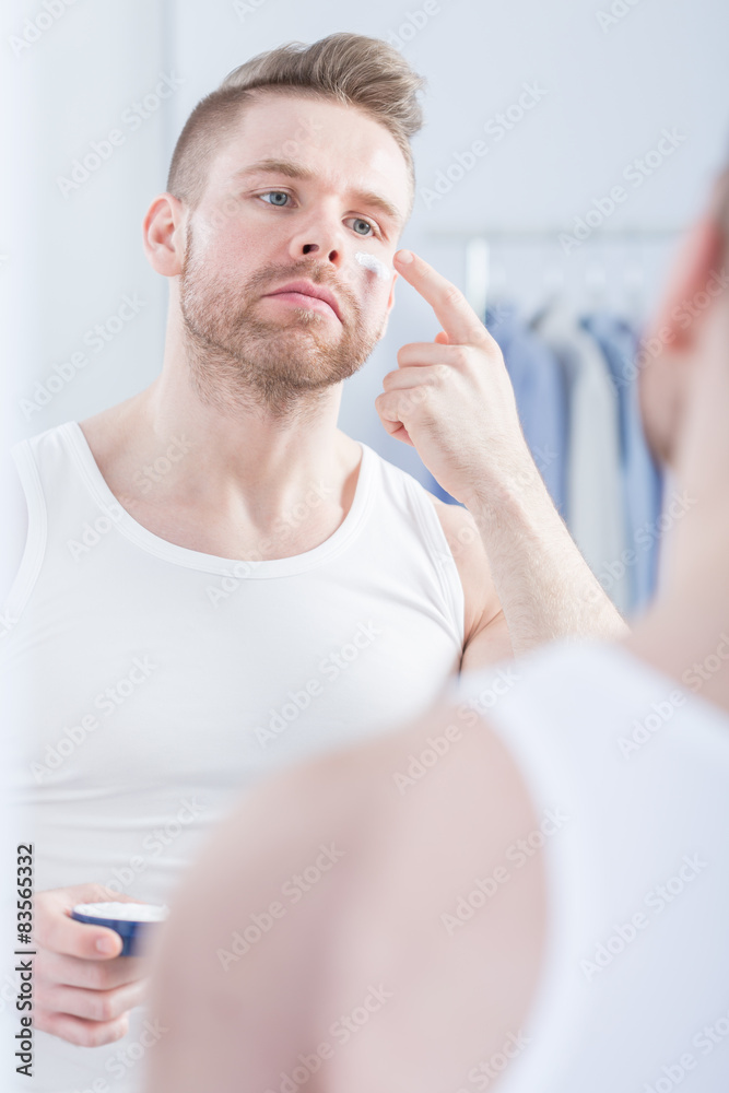 Man using face cream Man using face cream