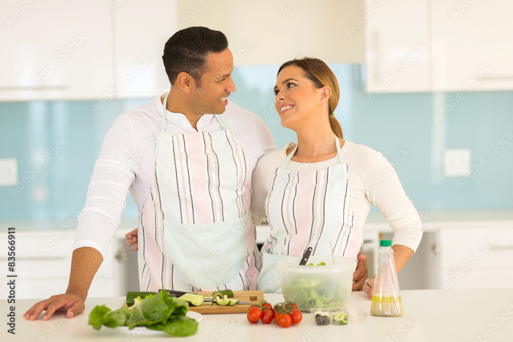 couple looking at each other in kitchen couple looking at each other in kitchen