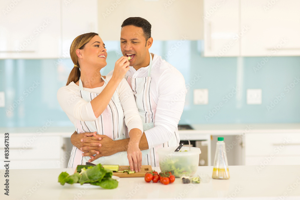 woman feeding boyfriend slice of cucumber