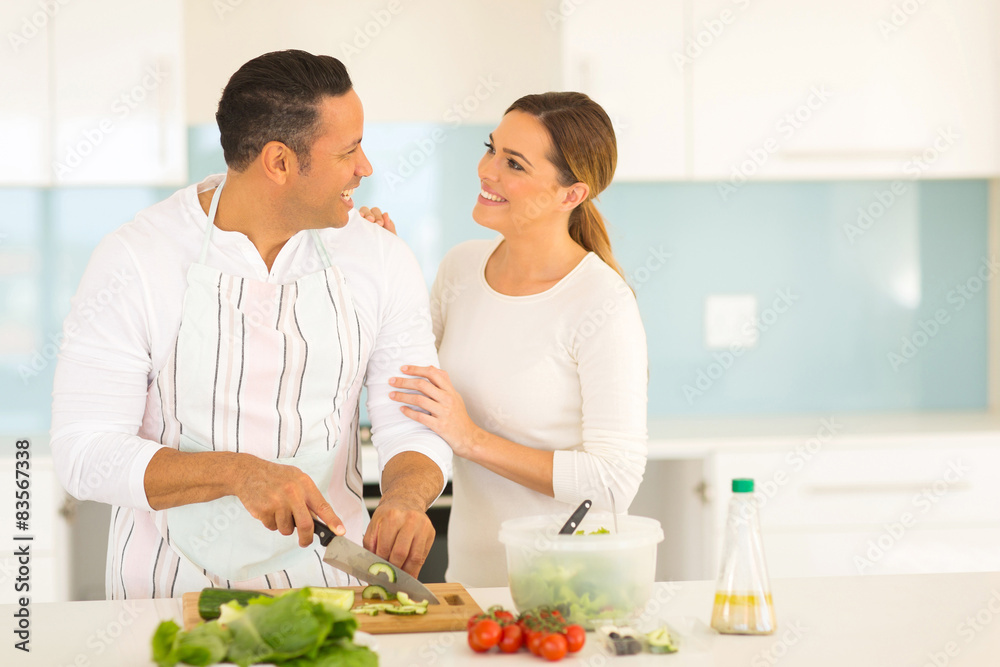middle aged couple in kitchen cooking