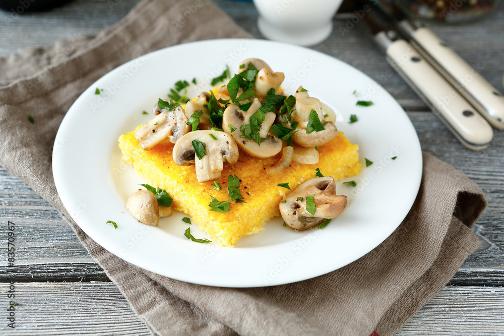 Tasty polenta with mushrooms in a plate Tasty polenta with mushrooms in a plate