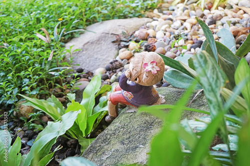 top view of clay girl doll decorated in garden