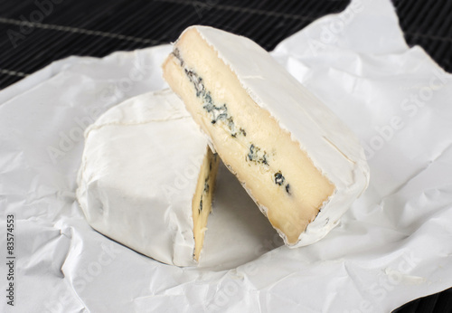 The cheese with a blue and a white mold