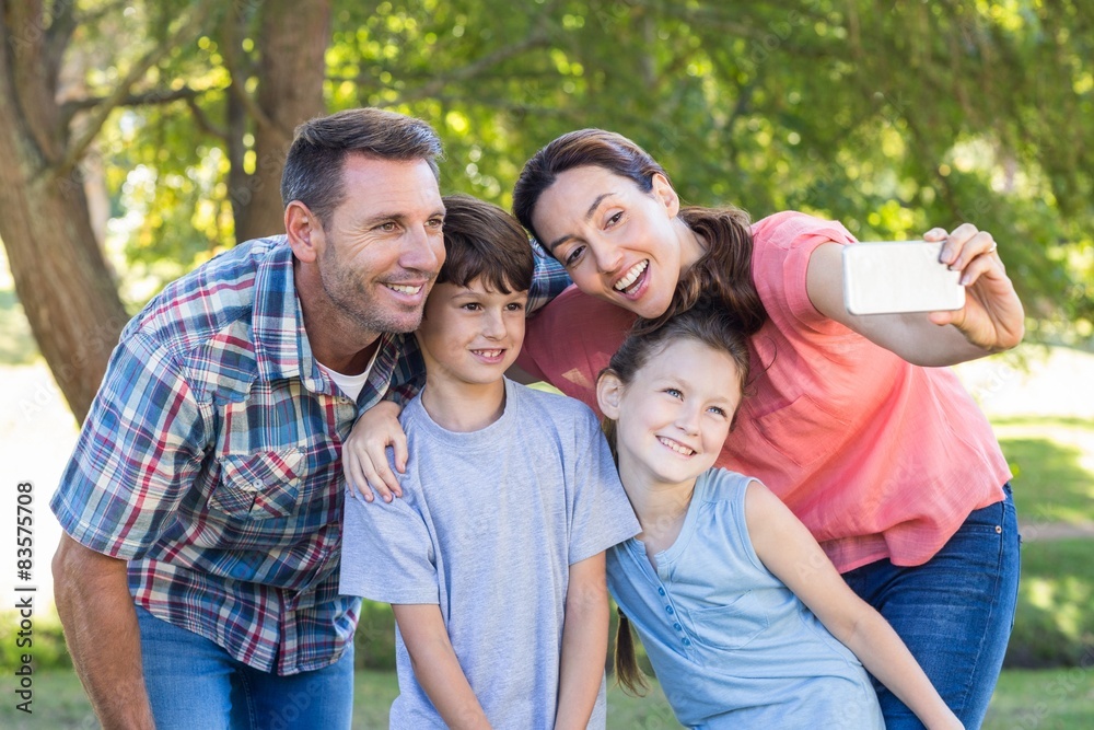 Happy family in the park taking selfie Happy family in the park taking selfie