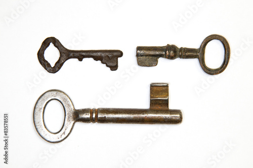 A lot vintage keys from the locks on a white background