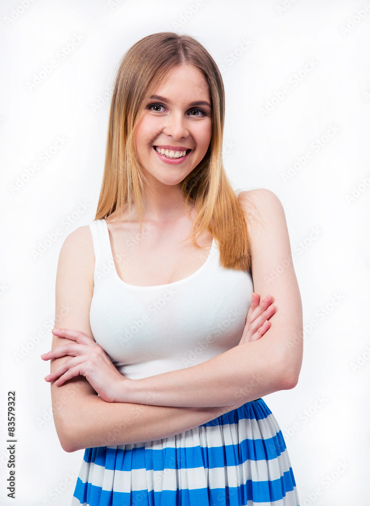 Smiling casual woman standing with arms folded Smiling casual woman standing with arms folded