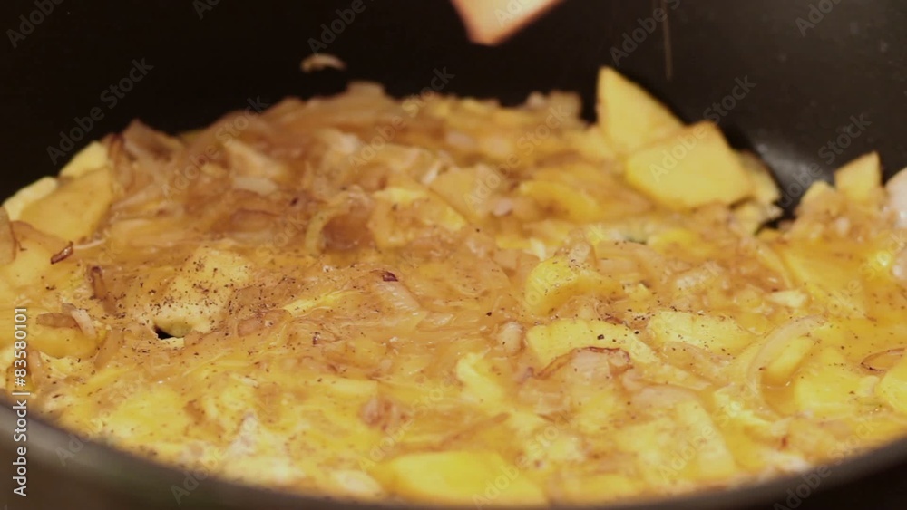 Omelet seasoning using pepper grinder, closeup Omelet seasoning using pepper grinder, closeup