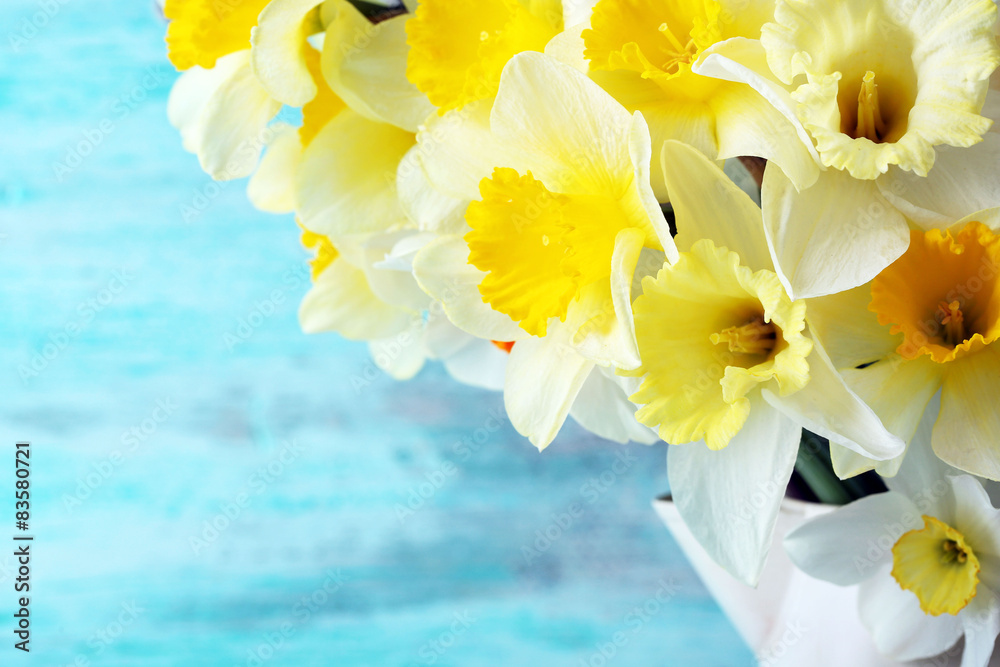 Fresh narcissus flowers on color wooden background Fresh narcissus flowers on color wooden background