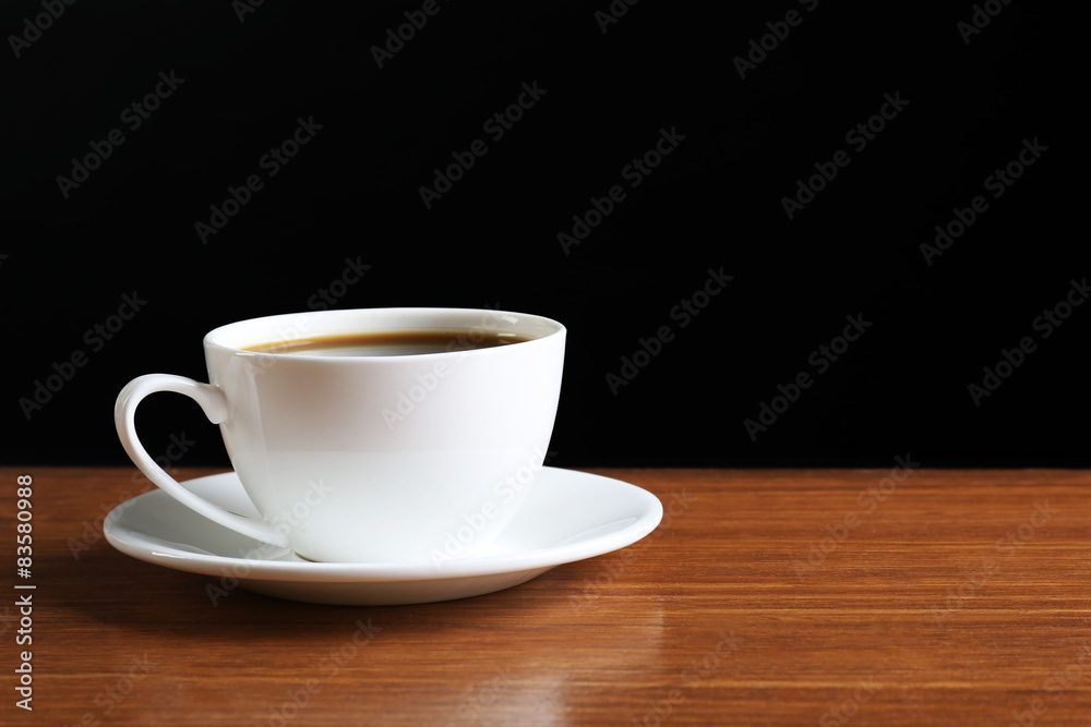 Cup of coffee on table on dark background Cup of coffee on table on dark background