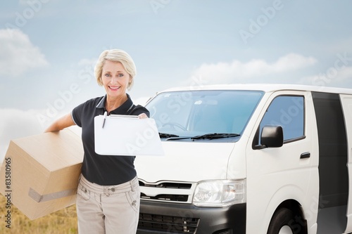 Composite image of happy delivery woman looking for signature © WavebreakMediaMicro