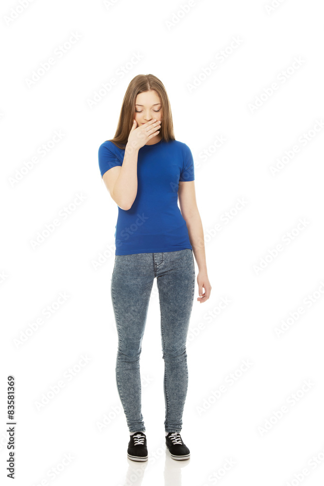 Disgusted teen covering her mouth. Disgusted teen covering her mouth.