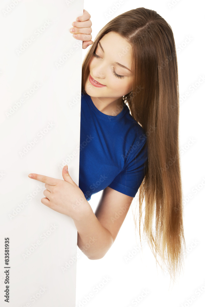 Happy woman pointing on blank board. Happy woman pointing on blank board.