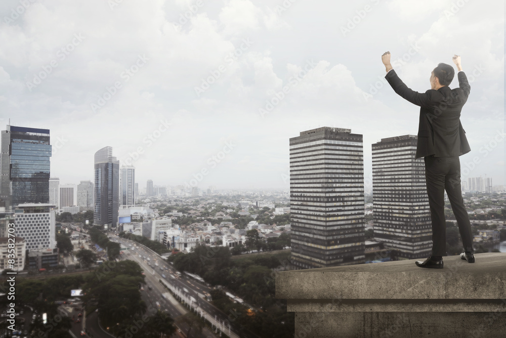 Business man shout on the building rooftop Business man shout on the building rooftop