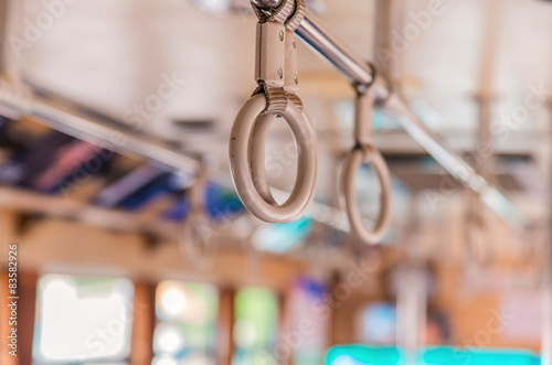 Handles on ceiling for standing passenger inside a bus