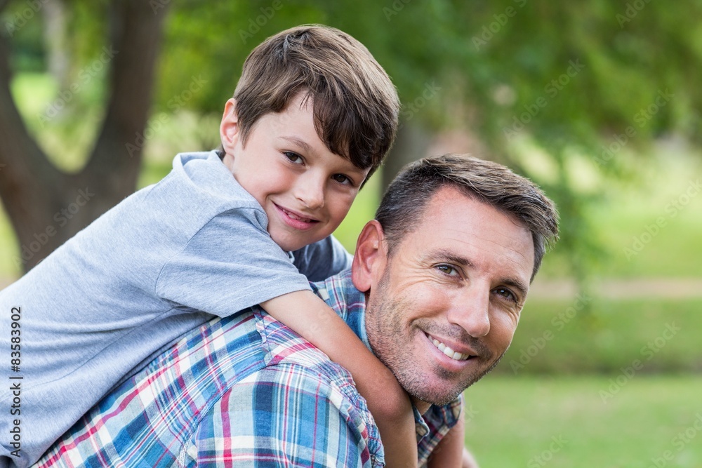 Father and son having fun in the park Father and son having fun in the park