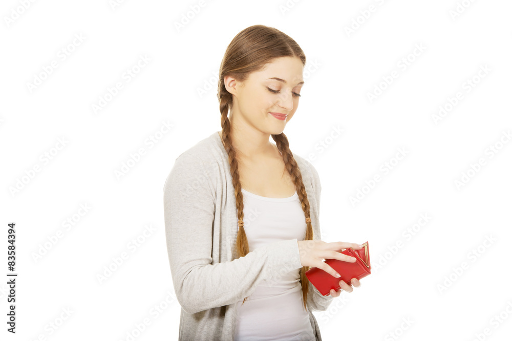 Happy teen woman with a wallet.