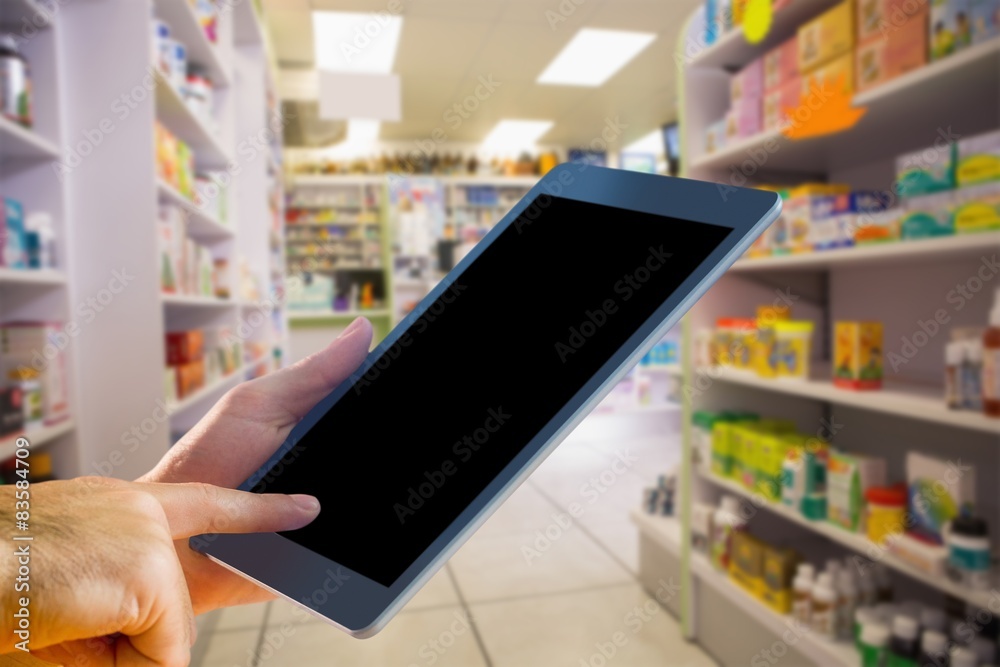 Composite image of man using tablet pc Composite image of man using tablet pc