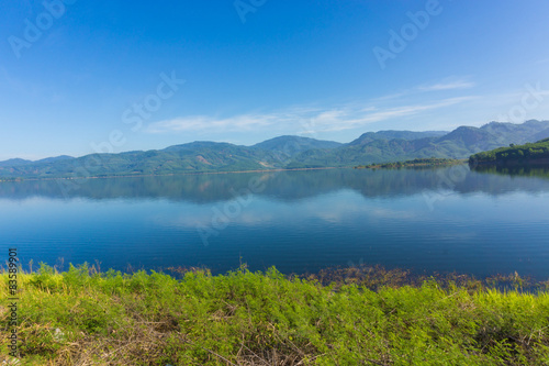 Fototapeta Naklejka Na Ścianę i Meble -  View of reservoir blue sky and green grass